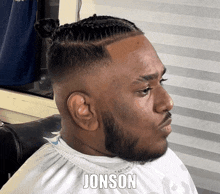 a man with a beard is getting his hair cut by the name of jonson