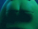 a close up of a green cartoon character 's face with a blue background and the letters jpm on the bottom