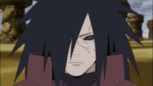 a close up of a naruto character 's face with a red eye and a black hair .