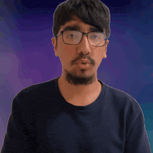 a man with glasses and a beard is making a gesture
