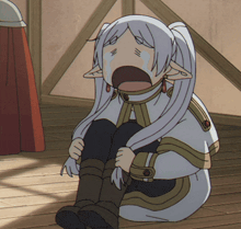 a cartoon character is sitting on the floor with her mouth open and crying