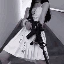 a woman in a white dress holding a gun