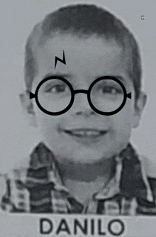 a black and white photo of a young boy wearing harry potter glasses and the name danilo