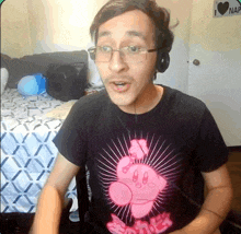 a man wearing glasses and headphones is wearing a shirt that says kirby