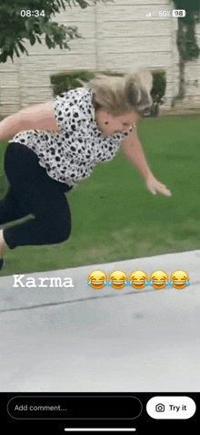 a woman in a dalmatian shirt is jumping on a trampoline .