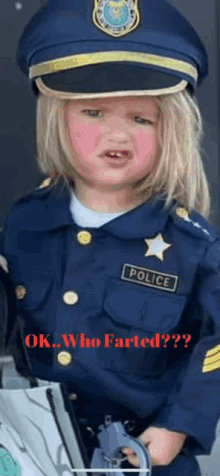 a little girl dressed as a police officer with a red face