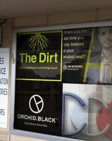 a window with a sign that says " the dirt " on it