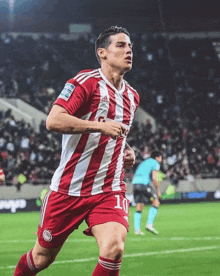 a soccer player wearing a red and white striped shirt with the number 10 on it