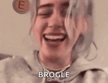 a close up of a woman 's face with the words brogle written on the bottom .