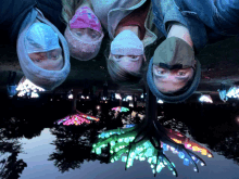 a group of people wearing face masks looking up at a tree