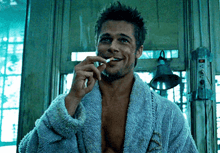 a man in a robe is smoking a cigarette
