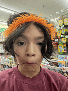 a child wearing an orange headband is standing in front of a shelf of crayola markers