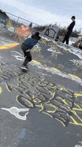 a person riding a skateboard in a skate park with graffiti on the wall that says " or get out "