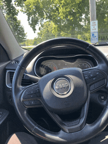 a jeep steering wheel with a park closed sign behind it