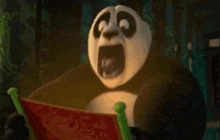 a panda bear is sitting on a chair with its mouth open .