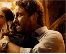 a man with a beard is hugging a woman in a movie poster .