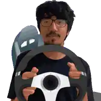 a man with glasses is holding a steering wheel in his hands
