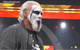 a man with a mask on his face is standing in front of a screen that says wrestling covers