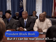 a group of men sit at a table with a blue button that says president black bush but if i can be real about it comedy c