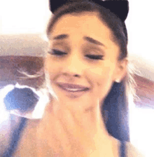 a close up of a woman wearing a cat ear headband .