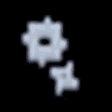 a blurred image of a gear with a hole in the middle on a black background .