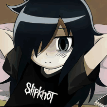 a girl wearing a slipknot shirt lays on a bed