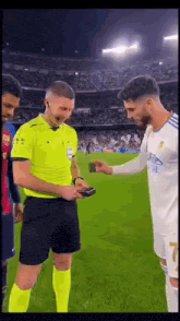 a referee is giving a wallet to a soccer player .