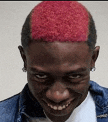 a man with red hair is smiling for the camera .