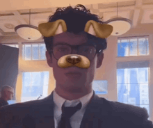 a man wearing glasses and a tie has a dog mask on his face