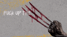 a poster that says " fuck up the whole damn program " with a hand holding bloody claws