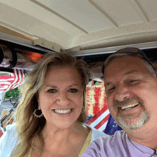 a man and a woman are smiling for a picture in a golf cart