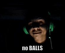 a man wearing green headphones says " no balls " in a dark room