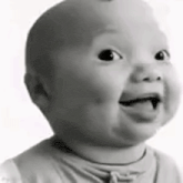 a baby is smiling in a black and white photo with his tongue out .