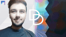 a man with a beard is smiling in front of a colorful background with the letter d