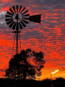 a windmill is silhouetted against a sunset sky with the word texas on it