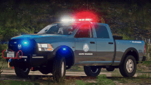 a game warden truck is parked on the side of a road