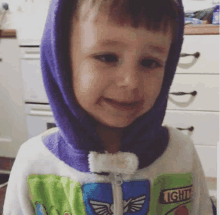 a little boy wearing a toy story costume with a hood