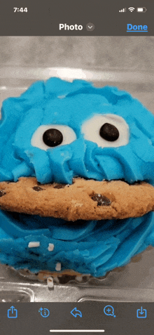 a phone screen shows a cookie monster with blue frosting on it