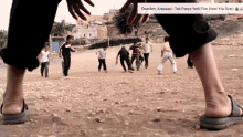 a group of children are playing soccer in a dirt field with a caption that says ' arapsci ' on it