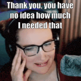 a woman wearing glasses and headphones says thank you