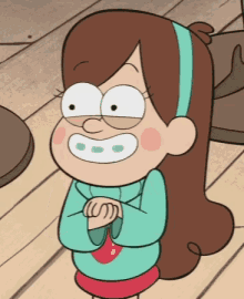 mabel from gravity falls is standing on a wooden floor with her hands folded .