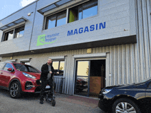 a man stands in front of a building that says magasin on it