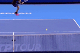 a tennis player is running on a court in front of a sign that says " next gen atp finals "