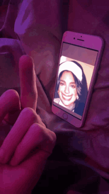 a phone with a picture of a woman smiling on the screen