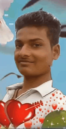 a young man in a white shirt is holding two red hearts in his hands .