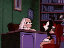 a cartoon of a man sitting at a desk with a picture on the wall that says ' a ' on it