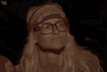 a woman wearing glasses and a headband that says survivor on it