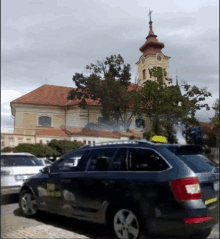 a taxi is parked in front of a large building