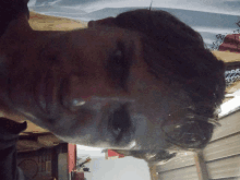 a close up of a man 's face with a reflection of a dog