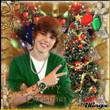 a picture of justin bieber with a christmas tree in the background says merry christmas